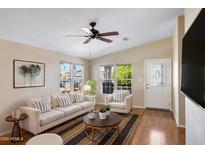Bright living room featuring neutral tones, a ceiling fan, and natural light streaming through the windows at 201 S Greenfield Rd # 173, Mesa, AZ 85206