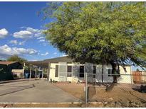 Charming single-story home featuring desert landscaping and a covered parking area, perfect for easy access at 2359 S Tomahawk Rd, Apache Junction, AZ 85119