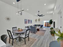 Bright, open-concept living room and dining area with modern decor and sliding doors to the patio at 3401 N 37Th St # 14, Phoenix, AZ 85018