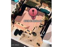 This aerial view showcases a beautiful home with a private pool and well-manicured landscaping at 4018 E Adobe Dr, Phoenix, AZ 85050