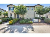 Charming two-story home featuring a manicured front yard with vibrant flowers and lush landscaping at 4046 S 58Th Ln, Phoenix, AZ 85043