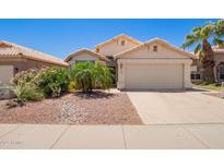 Charming single-story home with a well-manicured front yard and attached two-car garage at 4441 E Desert Wind Dr, Phoenix, AZ 85044