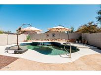 Beautiful pool with tanning ledge, water feature, and sun shades at 4712 E Lone Cactus Dr, Phoenix, AZ 85050