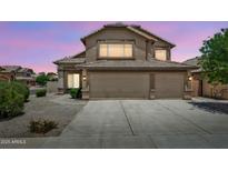 Charming home featuring a well-maintained front yard and a spacious three-car garage at 664 E Windsor Dr, Gilbert, AZ 85296