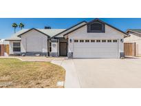 Charming single-story home featuring stucco siding, a two-car garage, and a well-maintained front yard at 676 W Shawnee Dr, Chandler, AZ 85225