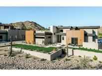Stunning contemporary home featuring desert landscaping, geometric architecture, and mountain views at 7215 N Black Rock Trl, Paradise Valley, AZ 85253