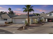 Charming home featuring desert landscaping, a palm tree, and a two-car garage at 7536 W Sequoia Dr, Glendale, AZ 85308