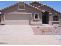 Single story home featuring a 2-car garage, desert landscaping, and neutral stucco exterior at 7716 W Pueblo Ave, Phoenix, AZ 85043
