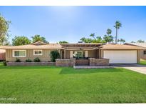 Charming single-story home with a well-manicured lawn and a covered front patio at 7802 N 6Th St, Phoenix, AZ 85020