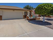 Charming single-story home featuring an attached two-car garage, brick accents, and a welcoming front patio at 8160 E Keats Ave # 364, Mesa, AZ 85209
