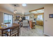 Open living area with a combined kitchen and dining space, featuring modern appliances and comfortable seating at 8160 E Keats Ave # 364, Mesa, AZ 85209