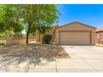Charming single-story home featuring a two-car garage and a well-maintained front yard with desert landscaping at 8321 W Hughes Dr, Tolleson, AZ 85353