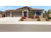Charming home with a two-car garage, beautiful stone accents, and professionally landscaped front yard at 8350 W Carole Ln, Glendale, AZ 85305