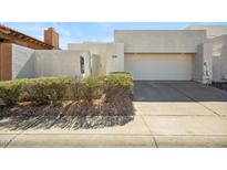 Contemporary home with a two-car garage, stucco exterior, and desert landscaping at 11079 N 110Th Pl, Scottsdale, AZ 85259
