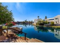 Beautiful waterfront view featuring canal access and lush landscaping at 1134 E Driftwood Dr, Tempe, AZ 85283