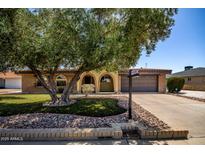 Charming single-story home featuring a well-manicured lawn and inviting curb appeal at 12811 N 44Th Dr, Glendale, AZ 85304