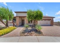 Charming single-story home with stone accents, a well-manicured yard, and a two-car garage at 17179 S 174Th S Dr, Goodyear, AZ 85338