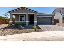 Inviting single-Gathering home featuring a well-manicured lawn and an attached two-car garage and a paver driveway at 21348 N Belt Dr, Maricopa, AZ 85138