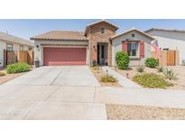 Charming single-story home featuring a welcoming brick entryway and a well-maintained, xeriscaped front yard at 24638 N 144Th Ave, Surprise, AZ 85387