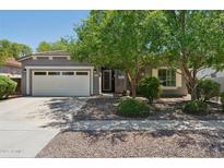 Charming single-story home with a two-car garage and mature shade trees in a well-maintained front yard at 2957 E Melrose St, Gilbert, AZ 85297