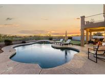 Inviting backyard pool with tanning ledge, lounge chairs, and a beautiful sunset view at 33828 N Pate Pl, Cave Creek, AZ 85331