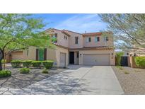 Inviting two-story home featuring a three-car garage, desert landscaping, and a classic tile roof at 3813 W Lapenna Dr, New River, AZ 85087