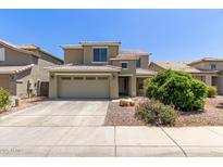 Two-story home with a two car garage, tile roof, and landscaped front yard at 3929 W Goldmine Mountain Dr, San Tan Valley, AZ 85144