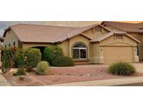 Charming single-story home featuring a well-maintained yard with desert landscaping and a two-car garage at 4322 E Cottonwood Ln, Phoenix, AZ 85048
