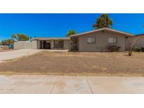 Charming single story home with a front yard and covered parking at 5738 W Heatherbrae Dr, Phoenix, AZ 85031