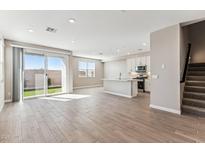 Bright open-concept living room with tile floors, recessed lighting, and sliding glass doors at 5844 E Covey Ln, Phoenix, AZ 85054