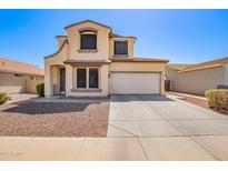 Charming two-story home with a two-car garage and low-maintenance desert landscaping in front at 6505 S 15Th Dr, Phoenix, AZ 85041