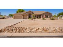 Charming single-story home featuring a well-maintained desert landscape, a three-car garage, and a welcoming entrance at 9658 W Golddust Dr, Queen Creek, AZ 85144