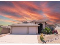 Charming single-story home with a desert landscape and a spacious three-car garage at 11424 S Obispo Dr, Goodyear, AZ 85338