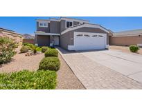 Charming two-story home with landscaped front yard, paved driveway, and a two-car garage at 12801 W Sweetwater Ave, El Mirage, AZ 85335