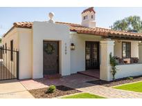 Close-up view of the home's entrance featuring a Spanish-style tiled roof and a decorative front door with a wreath at 1309 W Lynwood St, Phoenix, AZ 85007