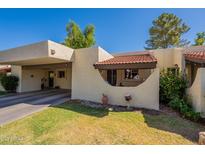 Charming single-story home with a landscaped front yard and a covered parking area at 131 N Higley Rd # 41, Mesa, AZ 85205