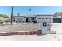 Charming single-story home featuring an arched entryway and low-maintenance desert landscaping at 2033 E Hillery Dr, Phoenix, AZ 85022