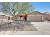 Charming single-story home featuring a low-maintenance desert landscape and a covered entrance at 20739 N 106Th Ln, Peoria, AZ 85382