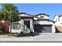 Charming two-story home featuring a well-manicured lawn and a welcoming covered entryway at 22812 N 123Rd Dr, Sun City West, AZ 85375