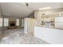 Open living space with a cozy fireplace and adjacent kitchen area at 2515 S Maple Ave # 103, Tempe, AZ 85282