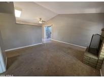 Living room with carpet, fireplace, sliding glass doors, and open floor plan at 2515 S Maple Ave # 103, Tempe, AZ 85282