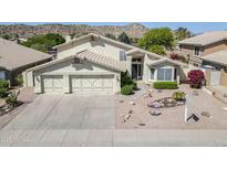 Inviting two-story home with a spacious three-car garage and xeriscaped front yard landscaping at 2629 E Verbena Dr, Phoenix, AZ 85048