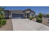 Charming single-story home with a two-car garage and well-manicured landscaping in a desirable community at 38082 W Santa Barbara Ave, Maricopa, AZ 85138