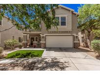 Two-story home with a two-car garage, landscaped front yard with decorative stone and a covered front porch at 4117 E Baylor Ln, Gilbert, AZ 85296