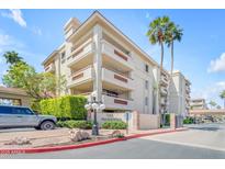 Charming condo complex with mature landscaping and sign; two-story building with private balconies at 4200 N Miller Rd # 112, Scottsdale, AZ 85251