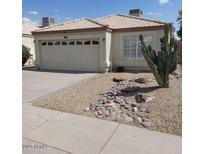 Charming single-story home featuring desert landscaping and a two-car garage at 4765 E Charleston Ave, Phoenix, AZ 85032