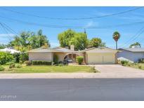 Charming single-story brick home featuring well-maintained landscaping and a spacious two-car garage at 504 N Emerson --, Mesa, AZ 85201