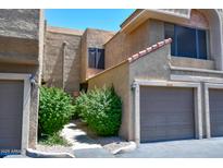 Attractive exterior featuring garage doors, desert landscaping and a walkway at 5122 E Shea Blvd # 1043, Scottsdale, AZ 85254