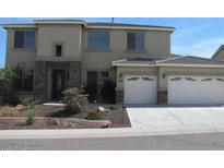 Two-story home featuring a two car garage, front yard with desert landscaping and neutral stucco and stone accents at 6619 W Cordia Ln, Phoenix, AZ 85083