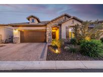 Charming home featuring stone accents, a brick driveway, and well-maintained landscaping at 6929 E Quill St, Mesa, AZ 85207
